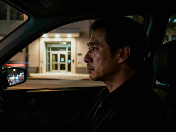 A young professional male, sat in the car, not wanting to enter his office building
